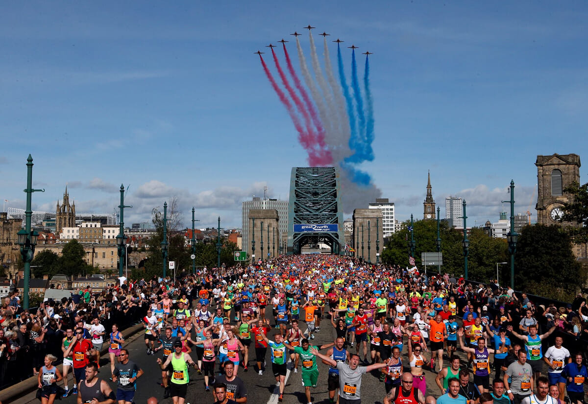 The Red Arrows fly over the race