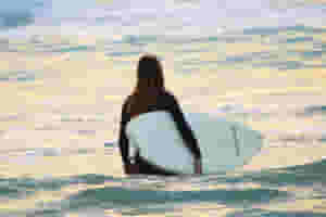 surfing woman with surfboard going to surf in ocean 1048