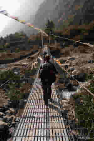 hikers crossing a bridge during the manaslu circuit trek 370