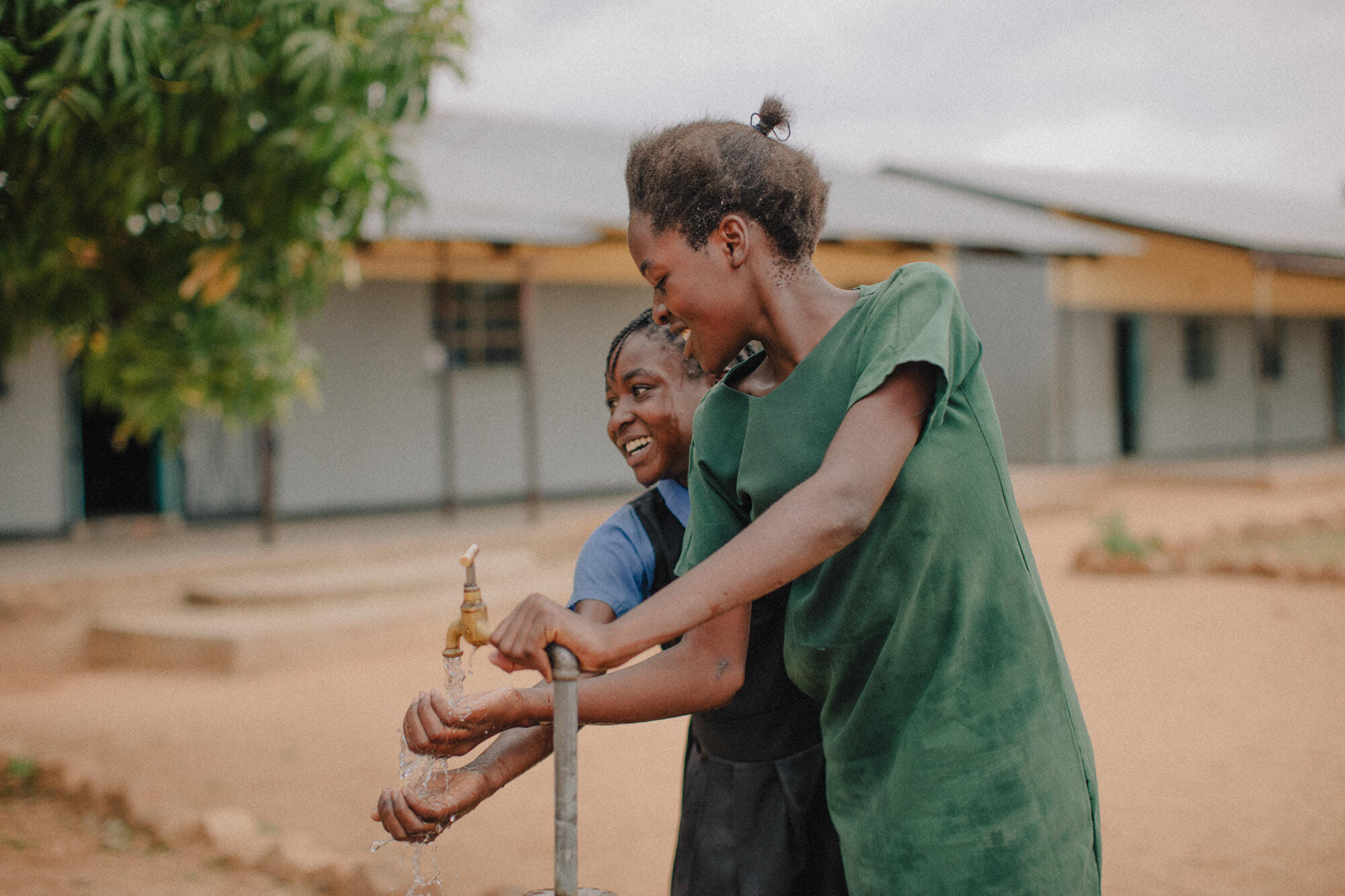 Students use their school water tap, Kazungula district, Zambia. November 2023. Credit WaterAid/ Laura Pannack